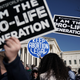 Pro-life activists try to block the sign of a pro-choice activist during the 2018 March for Life January 19, 2018 in Washington, DC. Activists gathered in the nation's capital for the annual event to protest the anniversary of the Supreme Court Roe v. Wade ruling that legalized abortion in 1973.